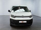 the white van is parked in a white room with a black floor