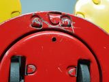 a red fire hydrant with a smiley face painted on it