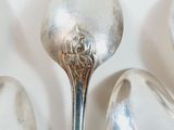 several spoons and spoon rest on top of each other on a white surface