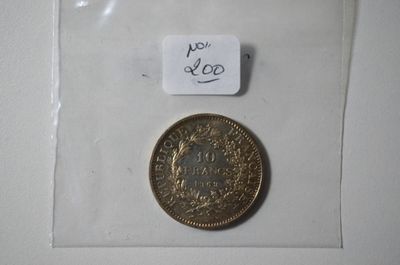 a small coin in a clear bag with a tag on it
