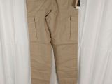 a pair of khaki cargo pants hanging on a hanger