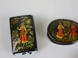 a small box with a painting on it next to a small box with a painting on it