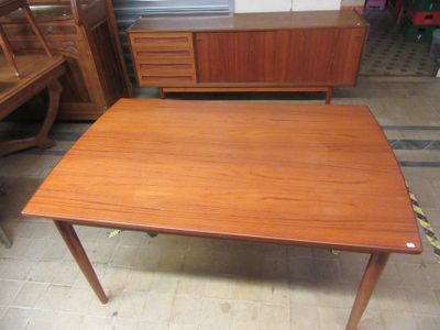 a wooden table with two drawers and a cabinet in the background