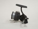 a close up of a fishing reel on a white surface