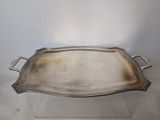 a silver tray with handles on a glass stand