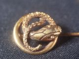 a gold brooch with a snake on it