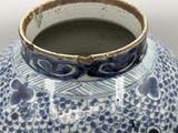 a blue and white vase sitting on a table