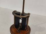 a clock that is sitting on a stand on a table