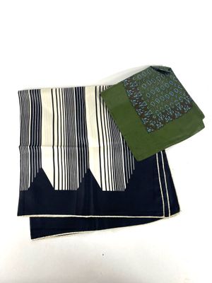 two pieces of cloth on a white table cloth