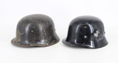 pair of black helmets with holes on them sitting next to each other