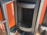 someone is opening the door of a stove to see what is inside