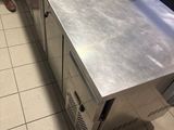stainless steel counter top in a commercial kitchen with a person standing next to it