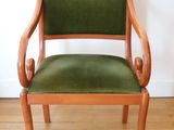 a green chair sitting on a hard wood floor