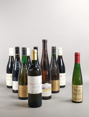 several bottles of wine are lined up in a row on a table