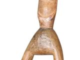 wooden figurine of a man sitting on a chair with a smile on his face