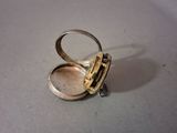 a silver ring that has a small silver object inside of it