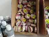 two boxes with different types of crafting supplies sitting on a table
