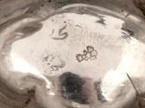 a close up of a silver plate on a table