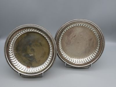 a pair of silver plated dishes with beaded rims