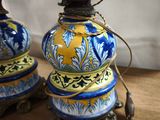 two lamps that are sitting on a wooden table