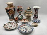 many different types of vases and plates on the table