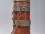 a small wooden box with a strap on it