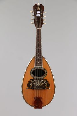 an image of a guitar hanging from a string on a wall