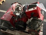 a red motorcycle sitting on a pallet on the street