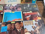 a lot of vinyl records on a table in a room