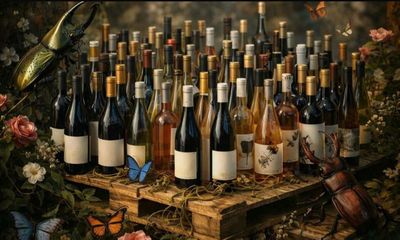 many bottles of wine sitting on a wooden pallet