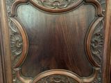 a wooden cabinet with a mirror on the door
