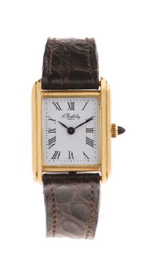 a close up of a gold wrist watch with roman numerals