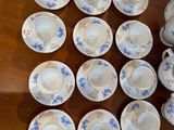 a lot of cups and saucers on the table