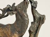 bronze sculpture of a stag with a bird on its antelope