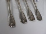 six silverware spoons and a fork on a white surface