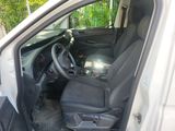 the interior of a car with the door open and the driver ' s seat down