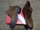 pair of brown boots on a red box on the floor