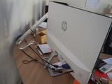 a computer monitor sitting on a desk with a keyboard and mouse