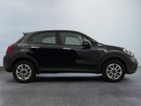 the small black car is parked in a room with gray walls