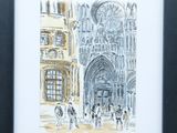 painting of people walking in front of a cathedral in a black frame