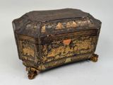 an old wooden box with a gold and black design on it