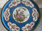 a blue plate with a picture of a woman and a bird on it