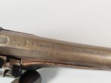 a close up of a gun on a white surface