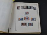 an open book with stamps on it sitting on a table