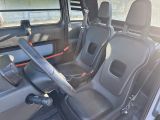two seats in the back of a car with a steering wheel