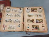 two open books with pictures of people and animals on them