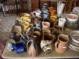 many different types of vases and bowls on the table