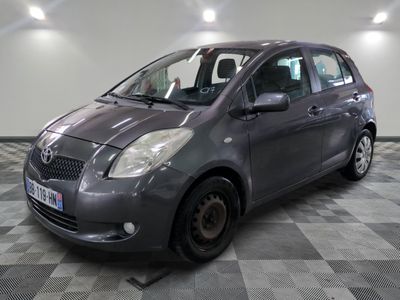 a picture of a grey toyota yaris parked in a garage