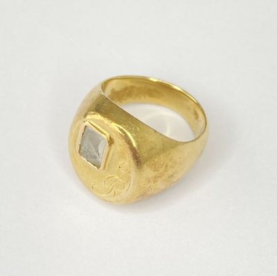 an image of a gold ring with a square stone in the center