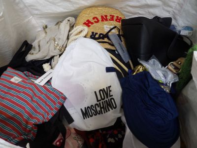 a pile of clothes and hats in a trash can
